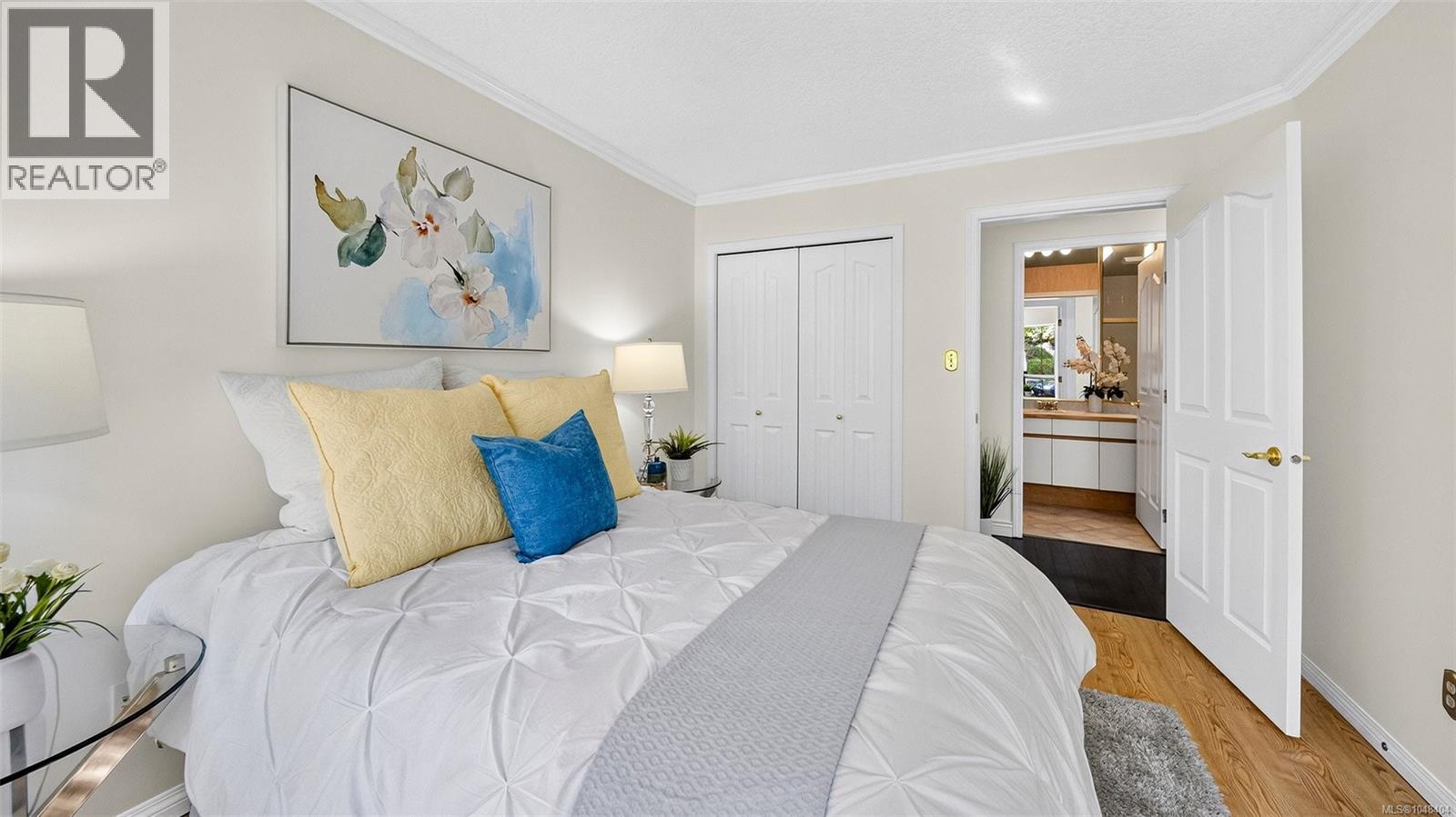 Second bedroom on the main. The closet is very deep and could house a Murphy bed or wet bar. The main floor bathroom is seen across the hall.