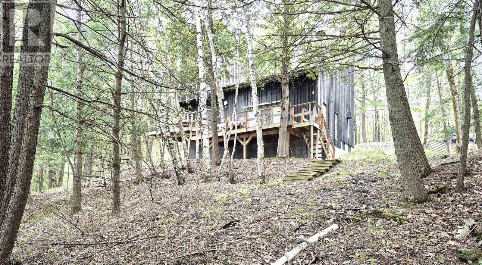 You'll love this ultra private treed Mary Lake estate sized property at the end of the road, with an original four bedroom year round chalet cottage with a full walkout basement. This is a full west, south west 255 feet full sized lake view property! Original lot well treed with a mix of hardwoods and Cedars with an easy walk to the dock, and has a nice hard sand natural shoreline! Build your ultimate dream home or improve and add to whats already here, you decide!! Easy to view. Full walkout basement with sauna! (id:48254)