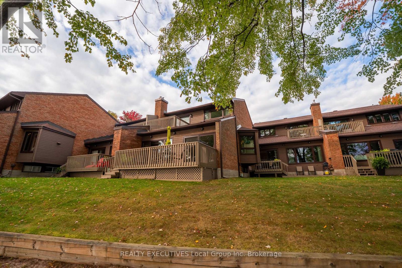 Experience waterfront living at its finest in this beautifully updated townhouse condominium overlooking the sparkling waters of Callander Bay. Offering a sought-after southwest exposure, this home captures stunning lake views and breathtaking sunsets from the comfort of your living room and private deck.  The main living area has been thoughtfully updated and features an open-concept kitchen with granite countertops, modern finishes, and excellent workspace for entertaining. The dining area overlooks the sunken living room, where a natural gas fireplace creates a warm and inviting atmosphere while large windows frame the waterfront setting.  Upstairs, you'll find three bedrooms, including a primary suite complete with a walk-through closet, private ensuite bath, and a charming Juliet balcony-an ideal spot to enjoy your morning coffee and lake breezes.  The lower level offers a versatile rec room, abundant storage space, and additional room that could be used as a home office, workout area, guest space, or future bedroom to suit your needs.  Additional features include an attached single-car garage and the potential opportunity to secure a dock slip, making it easy to enjoy boating and all that Lake Nipissing has to offer. The beautifully maintained condominium grounds provide exceptional privacy, mature gardens, and a peaceful waterfront setting that is rarely found.  Whether you're looking for a year-round residence or a low-maintenance waterfront retreat, this exceptional home offers the perfect combination of comfort, style, and lakeside living. (id:48254)