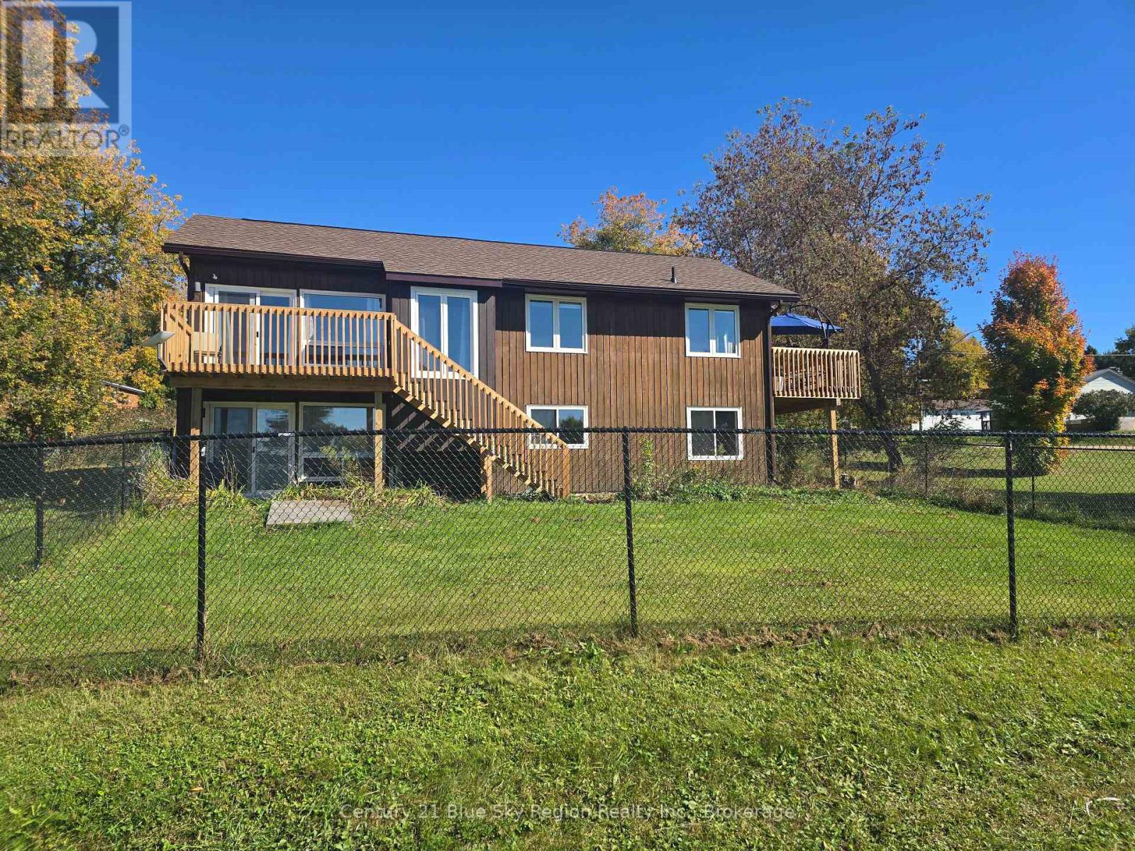 Welcome to 203 Labrecque in beautiful Bonfield! Set on a corner lot, this nicely updated bungalow offers a basement walkout to the backyard and lovely views of Lake Nosbonsing from its two balconies. Move-in ready and carpet-free, the home features new laminate flooring throughout, with tile in the basement office. The kitchen was updated in 2025 with new cabinets, a kitchen island, and granite countertops. Major improvements include a new furnace and heat pump with central air, new shingles (2025), and new windows, exterior doors, and patio doors (2024). A fresh coat of paint throughout much of the home adds to its welcoming feel. Enjoy your morning coffee or evening sunsets from either of the two replaced balconies-one off the kitchen and one off the living room-each with stairs leading down to the yard. Outside, a fenced 50-by-50-foot area is ready for your animals, and a newly poured 24-by-20-foot concrete pad is prepared for a future garage or Quonset hut. Quonset hut components are included; the pad and hut are estimated to have an approximate value of $35,000. Discover all that Bonfield and Lake Nosbonsing have to offer at 203 Labrecque. (id:48254)