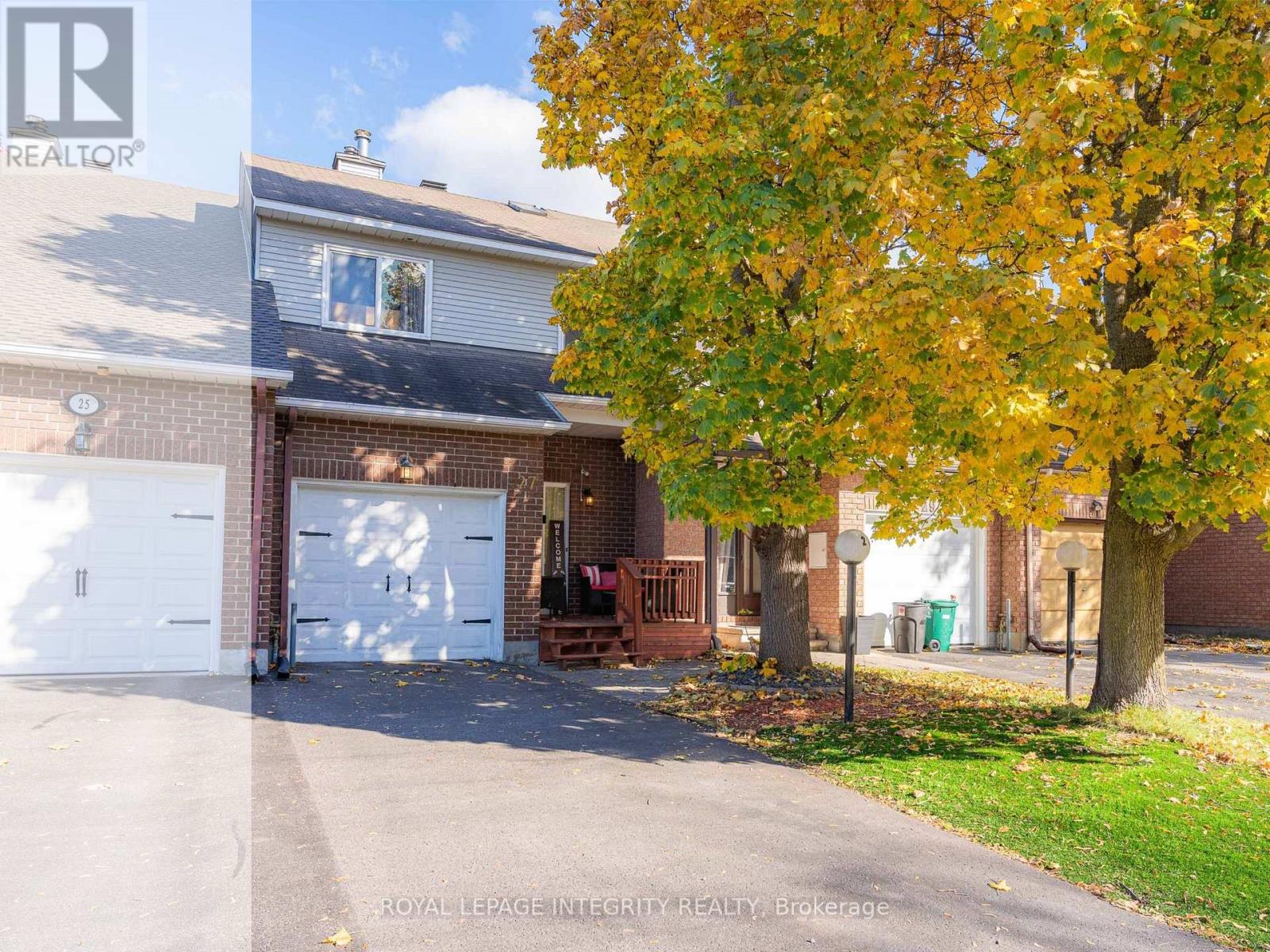 Welcome to 27 Danaher Drive! Located in Barrhaven's established Heritage Park community, this well-maintained freehold townhouse faces a quiet court and offers 3 bedrooms, 2.5 bathrooms, and approximately 1,768 sq. ft. of living space, including the fully finished basement. The home is carpet-free throughout, offering comfort and easy maintenance. An inviting front porch provides a lovely space to enjoy your morning coffee or unwind after a long day. Step inside to a bright and spacious living and dining area, featuring brand-new living room flooring (2026) and updated lighting. The functional kitchen offers extensive cabinetry, a stylish mosaic tile backsplash, pot lights (2020), and several upgraded appliances, including the dishwasher (2024), stove (2023), and microwave (2022). A skylight above the staircase brings additional natural light into the home. Upstairs, you'll find three well-proportioned bedrooms, including a spacious primary bedroom with a walk-in closet and private ensuite, along with an additional full bathroom. The fully finished basement offers flexible living space, highlighted by a charming wood-burning fireplace with a decorative stone surround, plus an additional finished room ideal for a home office, gym, or recreation area. Step outside to a fully fenced backyard featuring a spacious wooden deck expanded in 2023, perfect for summer barbecues and entertaining. Major updates include a new front door (2025), A/C (2019, rental), owned furnace (2016), updated upstairs bathrooms, and flooring improvements over the years. Conveniently located near schools, parks, shopping, restaurants, and everyday amenities, this home offers a wonderful combination of comfort, functionality, and convenience. Welcome home! (id:48254)