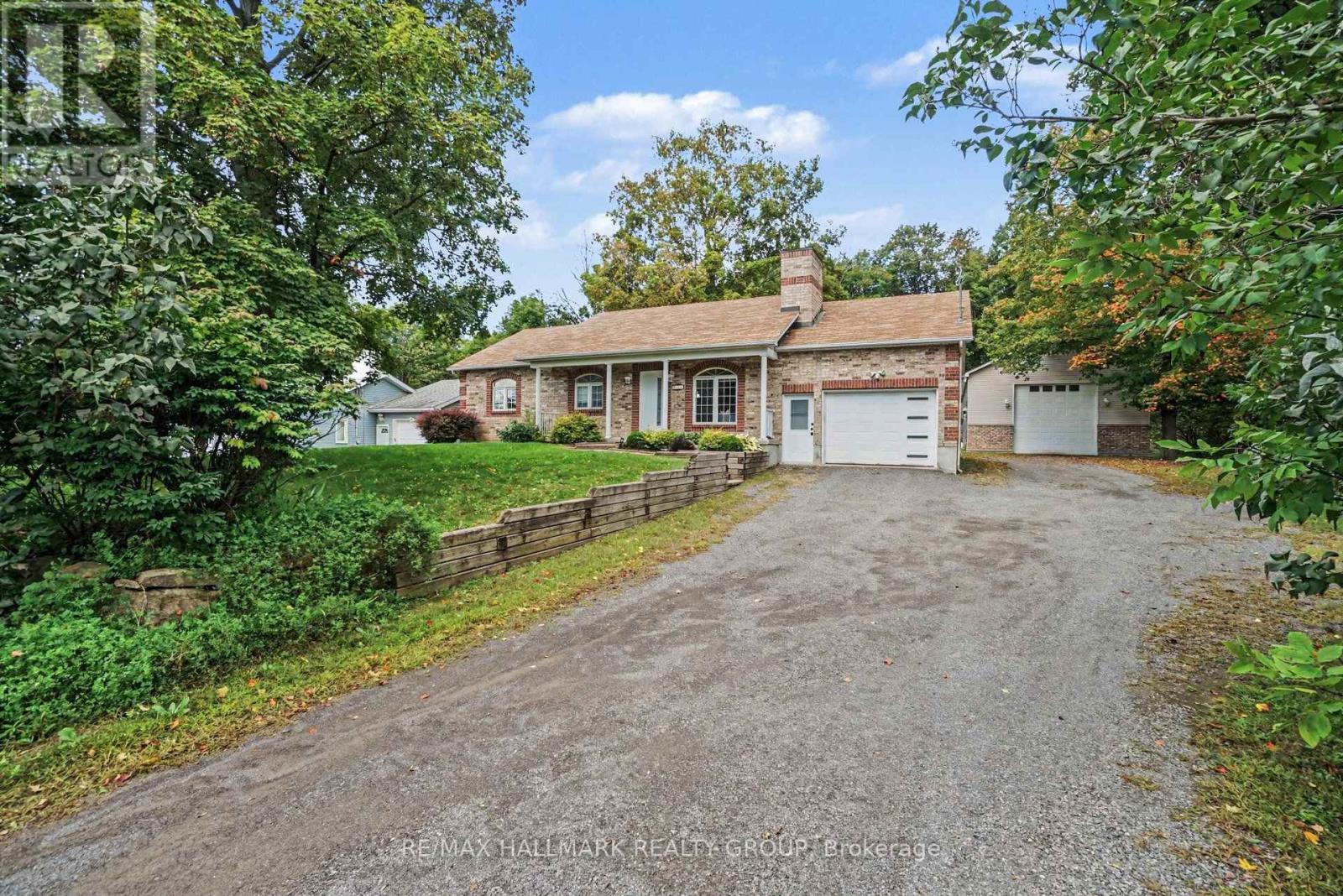 Gorgeous fully updated 3 bedroom, 3 bathroom home backing onto a forest and a 25' x 50' detached heated and insulated shop w/hoist. Located between Findlay Creek and Greely you are close to many amenities while still enjoying a peaceful country lifestyle. Loaded with updates, the main level features a formal living area with gas fireplace, stunning family room with vaulted ceilings and gas fireplace, full bathroom w/jacuzzi tub, 2 good sized bedrooms including a primary w/2 piece ensuite and laundry, dining area, and a beautiful kitchen w/quartz counter tops, island and stainless steel appliances. The lower level has plenty of options with a 3rd bedroom, full bathroom, large living space, storage areas, utility room, and another large finished space. Whether you need an in-law suite, teen retreat, man cave, gym area, games room or more, with this basement, you can have it all. Oversized single attached garage with inside access to the main level, as well as the lower level, bodes well for that in-law suite or potentially a secondary dwelling unit. If looking for a home based business(or you just need a massive shop), this one comes with a heated an insulated 25'x50'( approx.) detached garage complete with a hoist, a 10'x12' door, and a 12' x 12' door. Also included is a Honeywell 2200KW standby generator to power the whole property(2025). If being surrounded by nature is for you, then finish this stunning property off with large mature trees, backing onto a forest, beautiful wild life with a variety of birds, and great front and rear lawns and landscaping. Extensive list of updates available that includes a new furnace & A/C(2026), basement all finished w/exception of some ceilings(2025-26). Schedule B to accompany all offers. 24 hours irrevocable. (id:48254)
