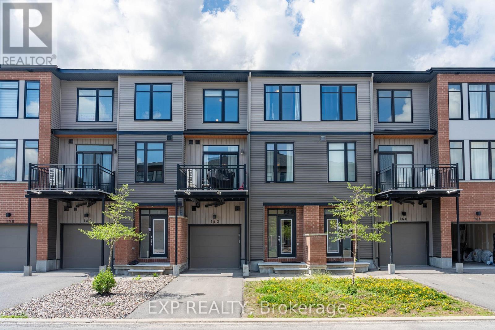 Perfectly situated in the sought-after Trailwest neighbourhood of Kanata, this SUN-FILLED FREEHOLD townhome is the kind of home you walk into and immediately think this is the one. The OPEN CONCEPT main level just feels good the second you step inside, with BEAUTIFUL oak-tone flooring underfoot, 9-FOOT CEILINGS overhead, and SOUTH-FACING windows flooding the space with natural light all day long. The contemporary kitchen is designed for real life, featuring upgraded cabinetry, STAINLESS STEEL appliances, white TILE BACKSPLASH, and an ISLAND that makes everything from weeknight dinners to weekend hosting feel effortless. Step out onto your PRIVATE BALCONY and soak up the sunshine, because this is the spot you will reach for every morning with your coffee and every evening winding down. Upstairs, the SPACIOUS primary bedroom is bright, generous, and comes with a WALK-IN CLOSET so DECEIVINGLY DEEP you will have to see it to believe it, genuinely rare for a townhome at this price point. The second bedroom is perfect for family, guests, or that home office you have been putting off setting up. The main bathroom has been BEAUTIFULLY UPGRADED with MATTE BLACK HEXAGON floor tiles and WHITE MARBLE-TONE counters for a clean, crisp, and effortlessly modern finish. LAMINATE FLOORING throughout the upper level keeps maintenance easy so you can spend your weekends actually living your life, not cleaning it. Convenient upper-level laundry means no more hauling baskets up and down stairs. Surrounded by parks, schools, trails, and everyday conveniences with Walmart, Costco, and restaurants just minutes away, this home delivers the LIFESTYLE you have been waiting for. An EXCELLENT opportunity for first-time buyers, downsizers, or investors who know a good thing when they see it! (id:48254)